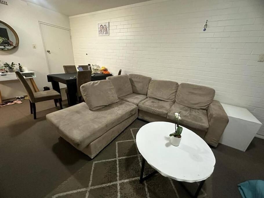 a living room with a couch and a table at Ozone point in Perth