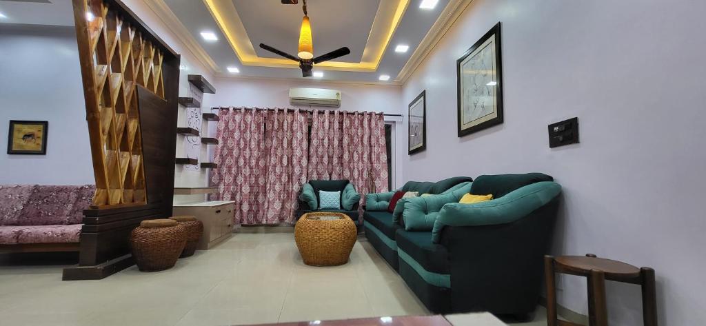 a living room with two couches and a couch at Homestay-a better living in Lucknow