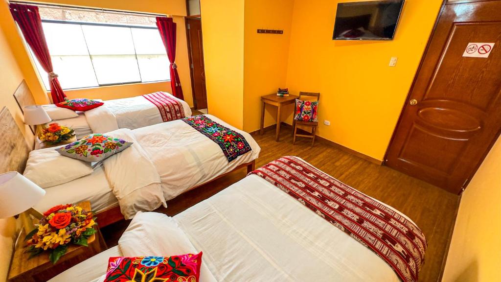 Postel nebo postele na pokoji v ubytování Andean Atoq Hostel
