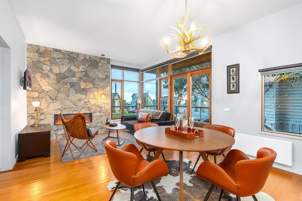 a living room with a table and chairs at Triggerplant 1 in Dinner Plain