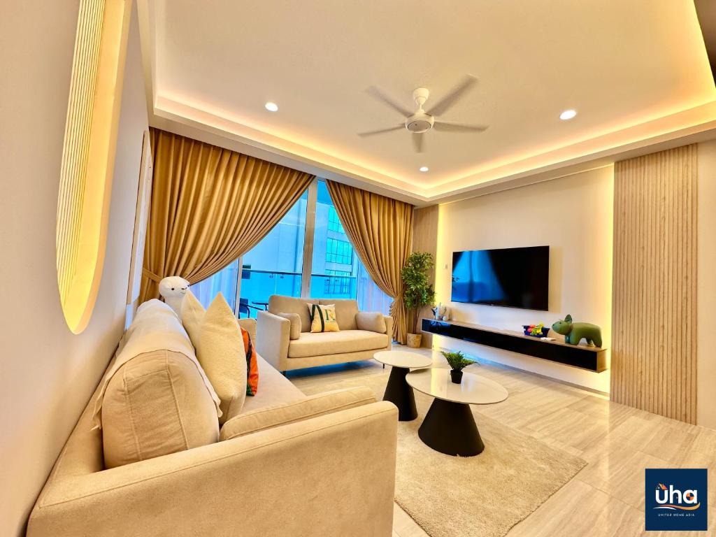 a living room with a couch and a tv at PineTree Puteri Harbour @ UHA in Nusajaya