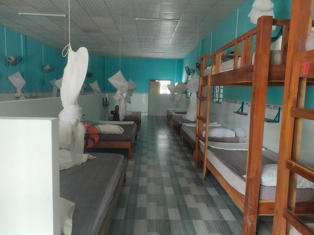 a room with several bunk beds and a hallway at PHU QUOC BACKPACKER in Phú Quốc