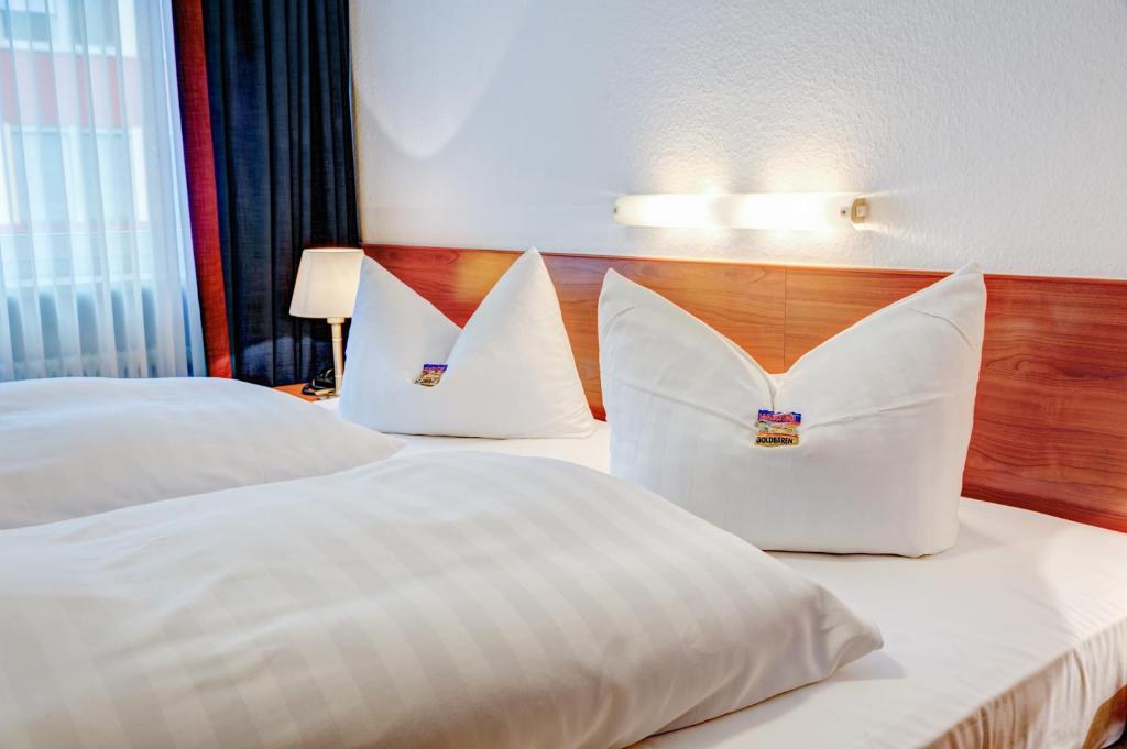 Postel nebo postele na pokoji v ubytování Hotel Antares München