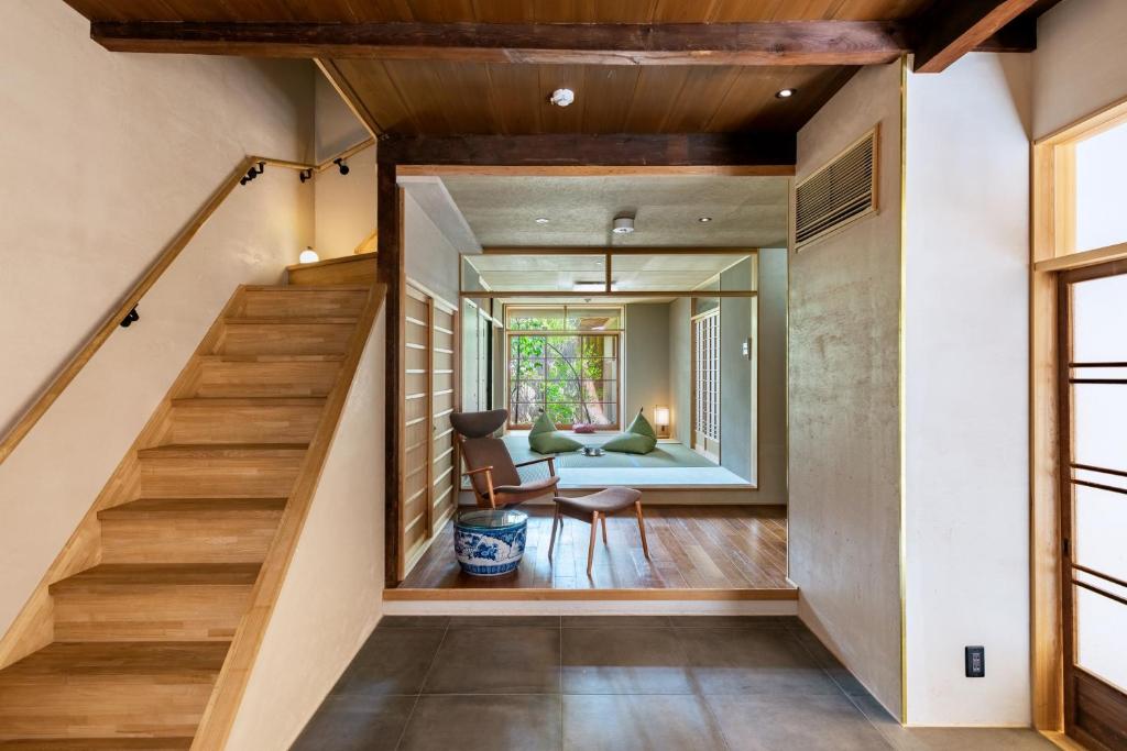 a staircase in a house with a living room at Choya Chawanzaka Machiya House in Kyoto