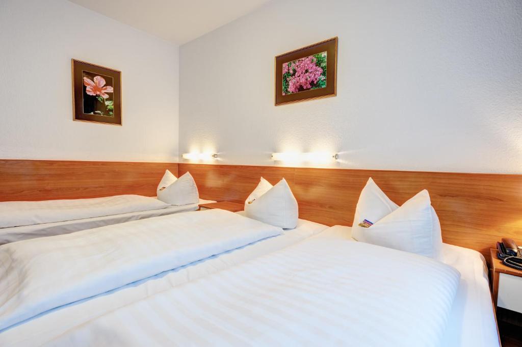 Postel nebo postele na pokoji v ubytování Hotel Antares München