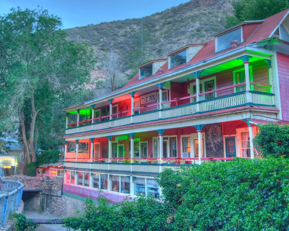 a large house with colorful balconies on a hill at The Inn at Castle Rock in Bisbee