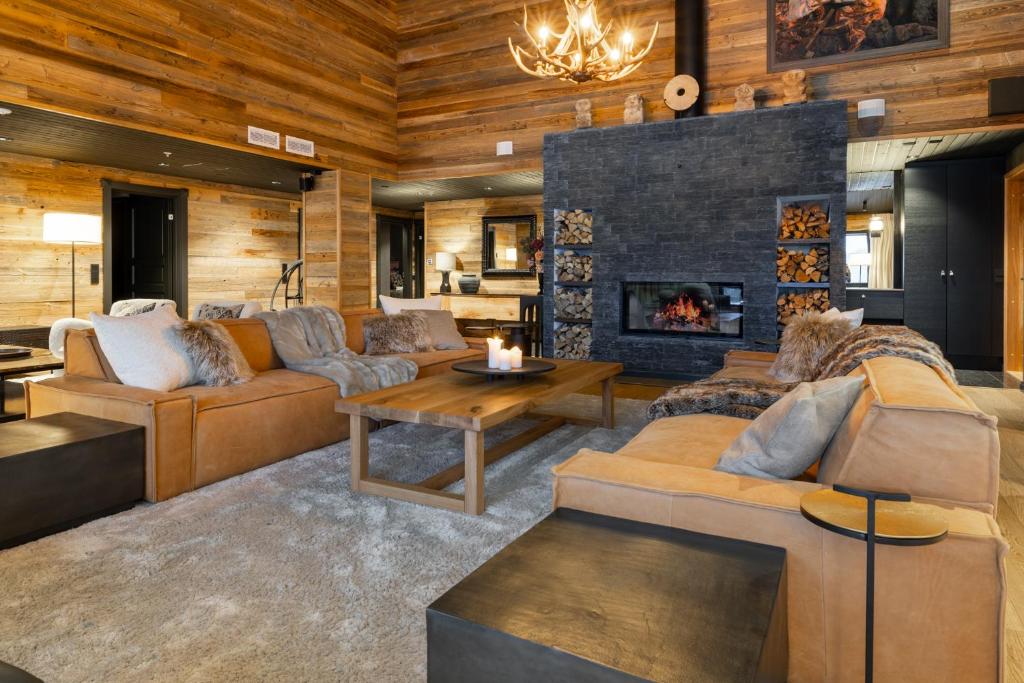 a living room with a couch and a fireplace at Penthouse Sammon in Levi