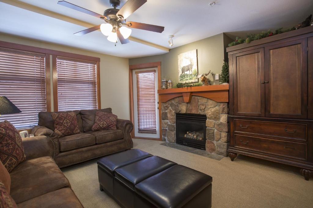 a living room with a couch and a fireplace at 1310 - One Bedroom Den Standard Eagle Springs West condo in Solitude