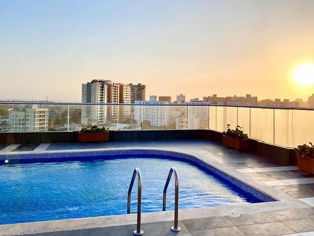 a swimming pool on the roof of a building at Apartaestudio Carnaval in Barranquilla