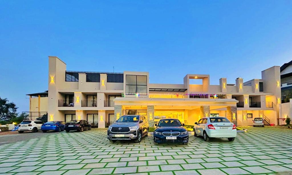 a group of cars parked in front of a building at VAGA NAKSHATHRA SUITES in Vagamon