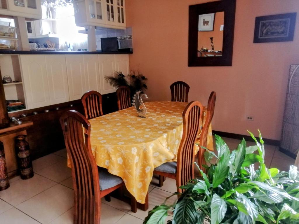 a dining room table with chairs and a yellow table cloth at Las Marias House in Choacorral