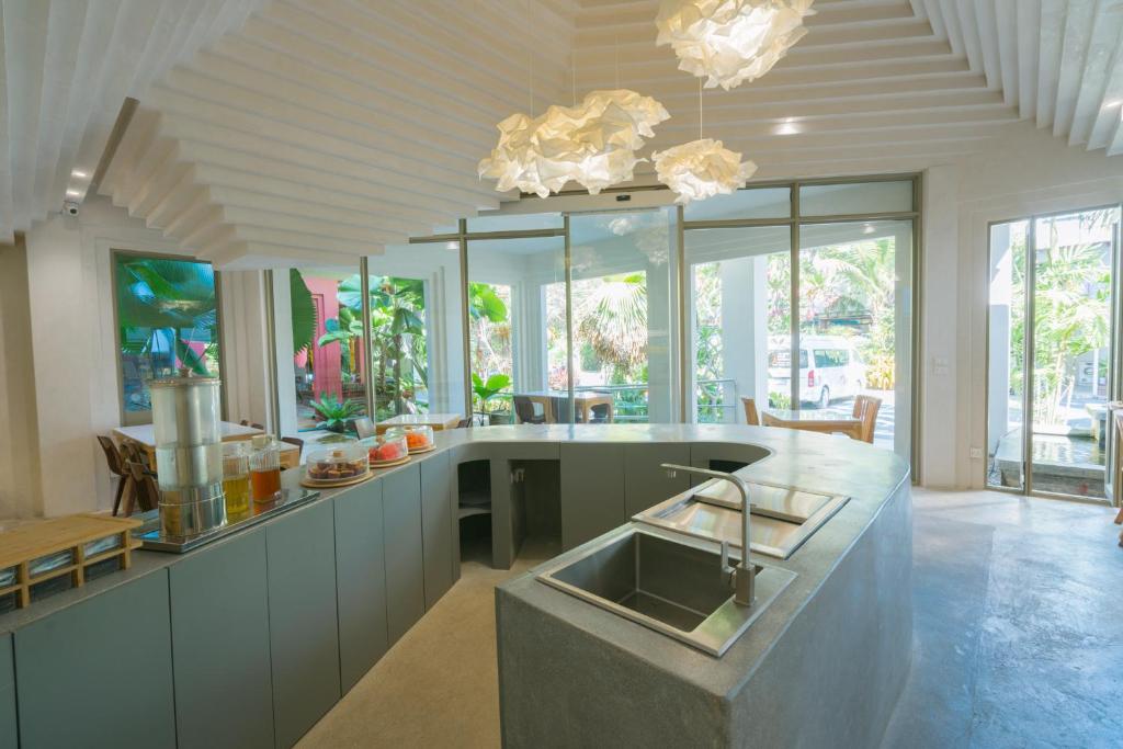 Open breakfast-service kitchen with buffet counters and a central sink island.