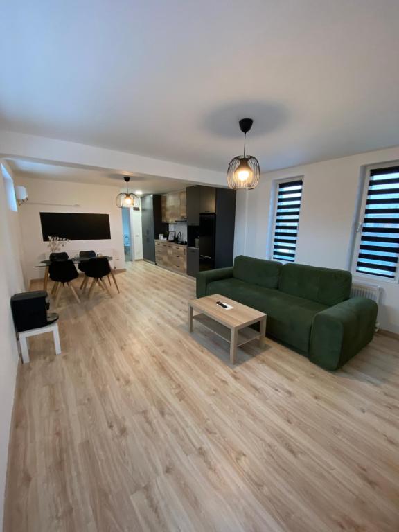 皮特什蒂TTT House Pitesti的客厅里有一张绿色的沙发和一张桌子