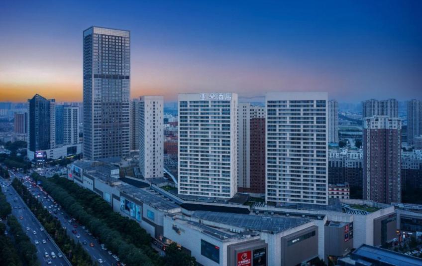 a city skyline with tall buildings and traffic in a city at Atour Hotel Xi'an Xixian Vientiane City in Xi'an