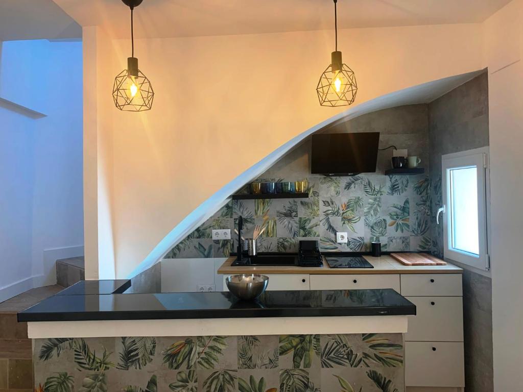 a kitchen with two pendant lights and a counter top at Home SEA&DREAMS OldTown V in Calpe
