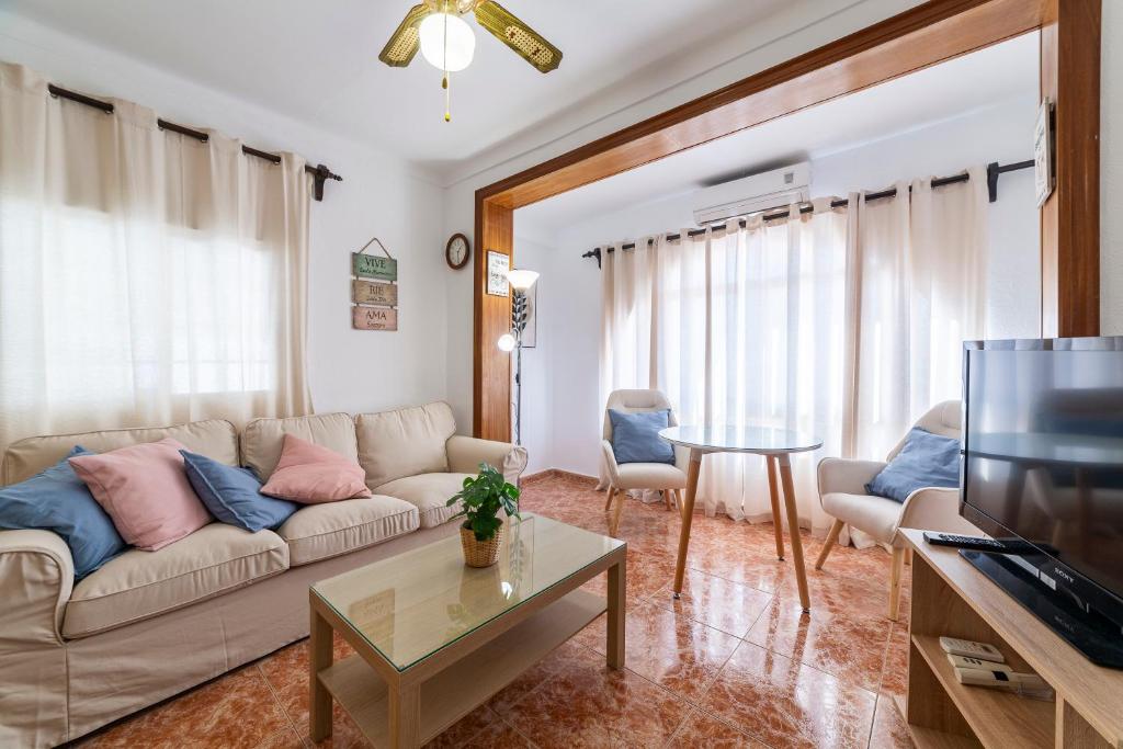 een woonkamer met een bank en een tafel bij Mi Locura Costa Cabana in Almería