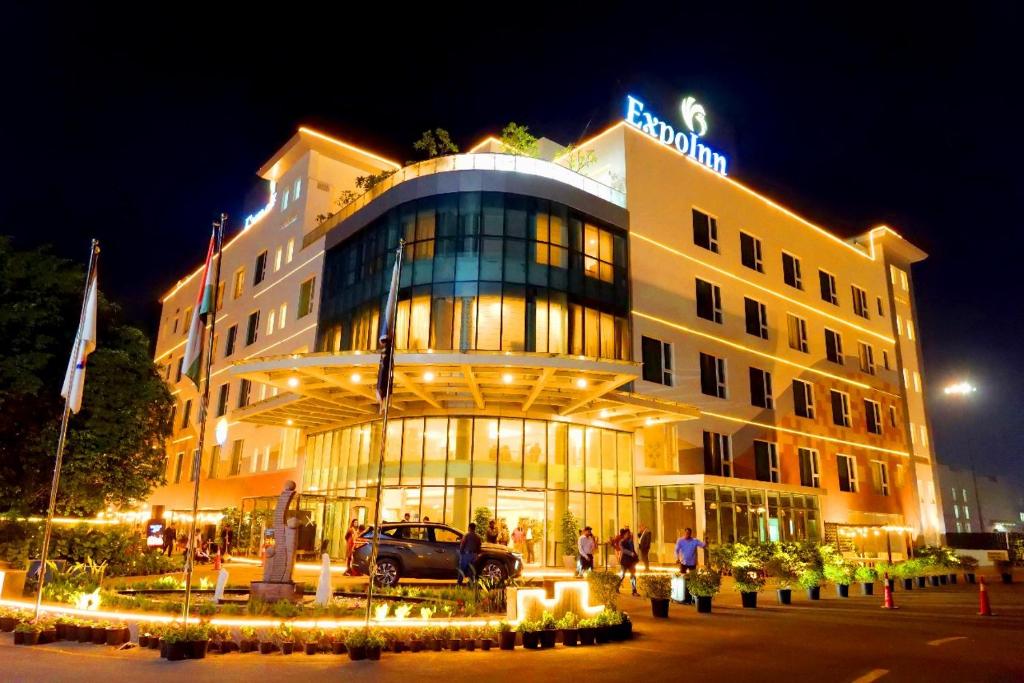 a hotel with a car parked in front of it at ExpoInn Suites and Convention in Greater Noida