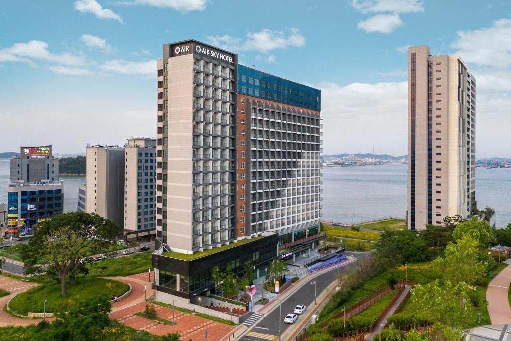 an aerial view of a tall building in a city at Airsky Hotel Incheon in Incheon