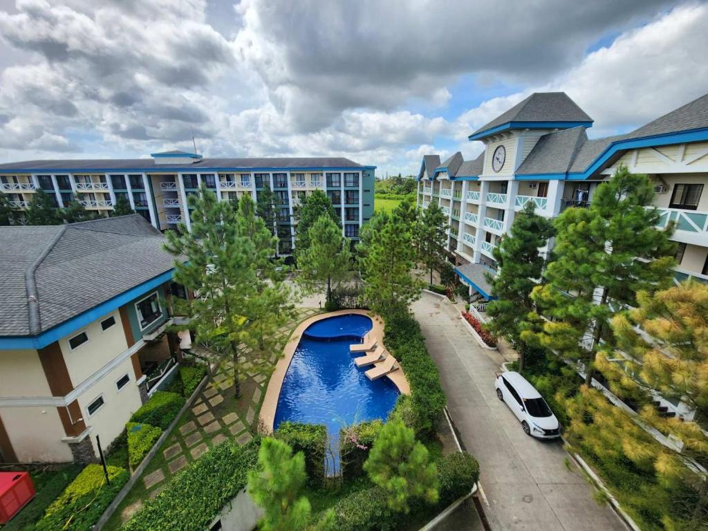 an aerial view of a apartment complex with a boat in the street at Pine Suites Tagaytay @ RoseAna Staycation in Tagaytay