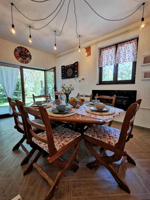 a dining room with a wooden table and chairs at Holiday home Sovica in Vrbovsko
