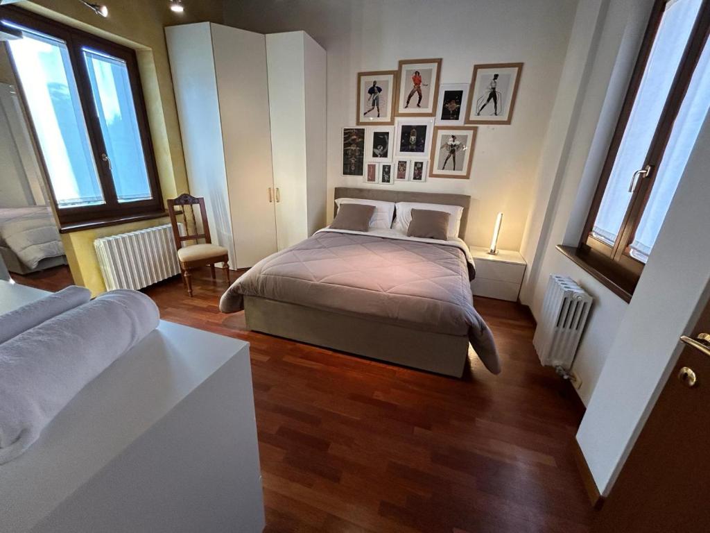 a bedroom with a bed and some windows at Valpolicella39 in Verona