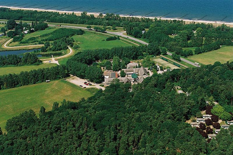 an aerial view of a house on a hill next to the ocean at Ferienresort Damerow in Ostseebad Koserow