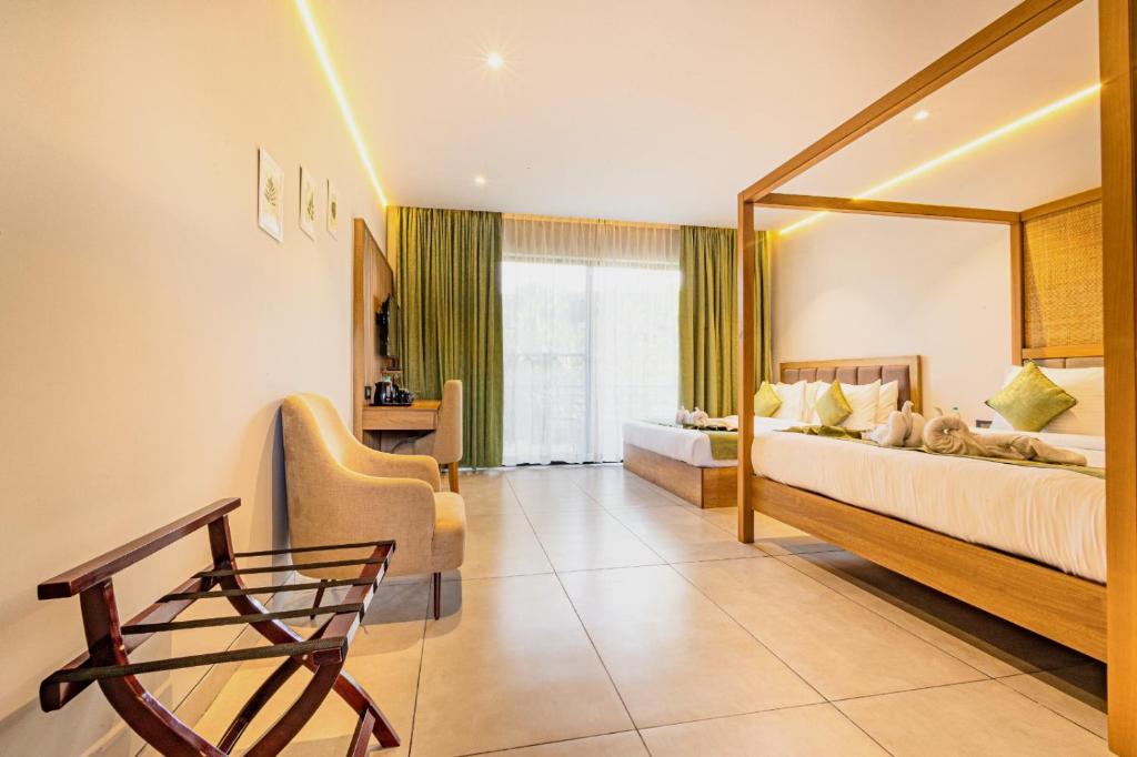 a hotel room with two beds and a mirror at The Vanya Luxury Boutique Resort in Bangalore