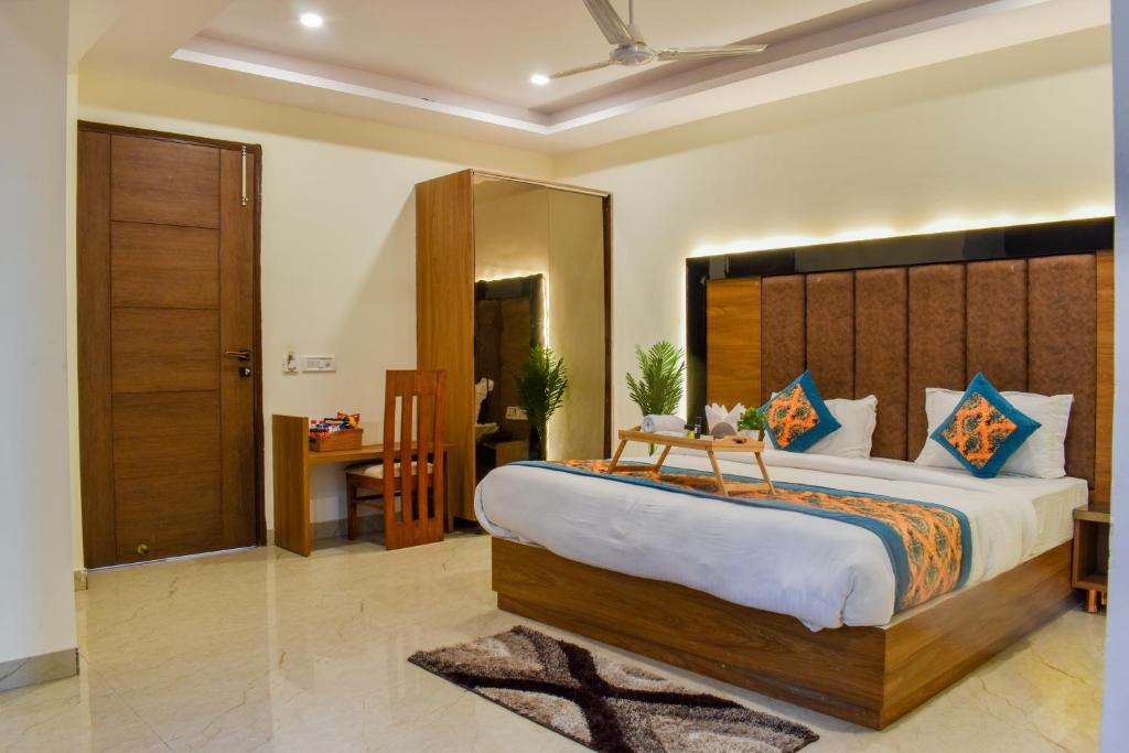 a bedroom with a large bed with a wooden headboard at HOTEL YASH PALACE in New Delhi