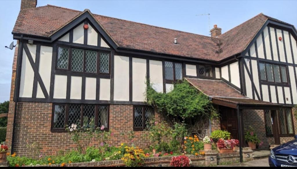 an old black and white house with at The GateHouse at Stansted in Hallingbury