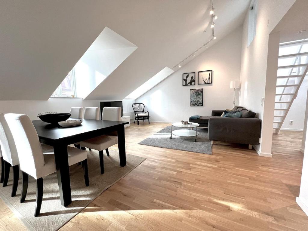a living room with a table and a couch at Elegant Apartment In The Heart Of The City in Gothenburg