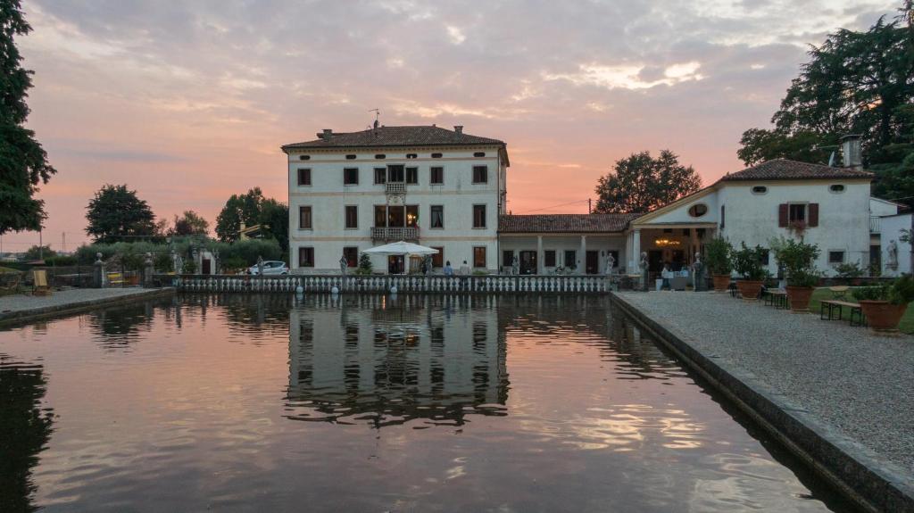 a building with a pond in front of it at Villa Stecchini in Bassano del Grappa