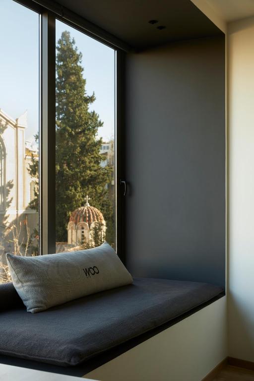 Postel nebo postele na pokoji v ubytování Athens Woo Suites