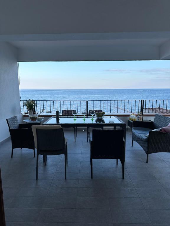 a living room with a view of the ocean at Casa Paloma in Letojanni