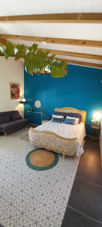 a bedroom with two beds and a blue wall at Le Poppy Palm in Sainte-Luce