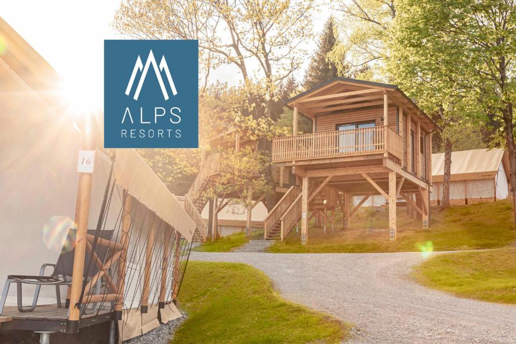 a log home with a sign that reads nips resorts at Chalets & Glamping Nassfeld by ALPS RESORTS in Kötschach