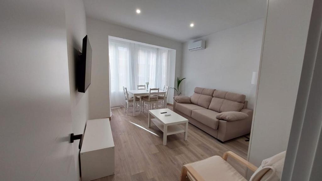 ein Wohnzimmer mit einem Sofa und einem Tisch in der Unterkunft Lemon Tree Home in Castellón de la Plana