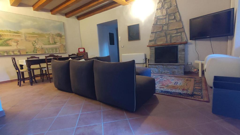 a living room with a couch and a fireplace at Gnazzano Home 2 in Loiano
