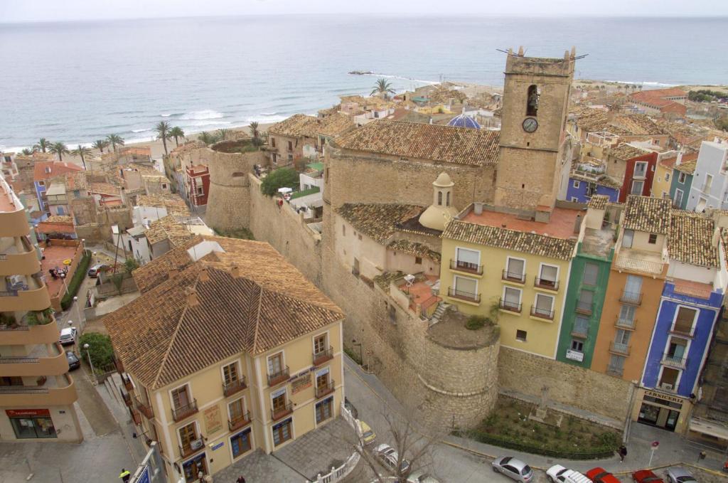 an aerial view of a city with a clock tower at HAPPYVILA Rustico Apartments in Villajoyosa