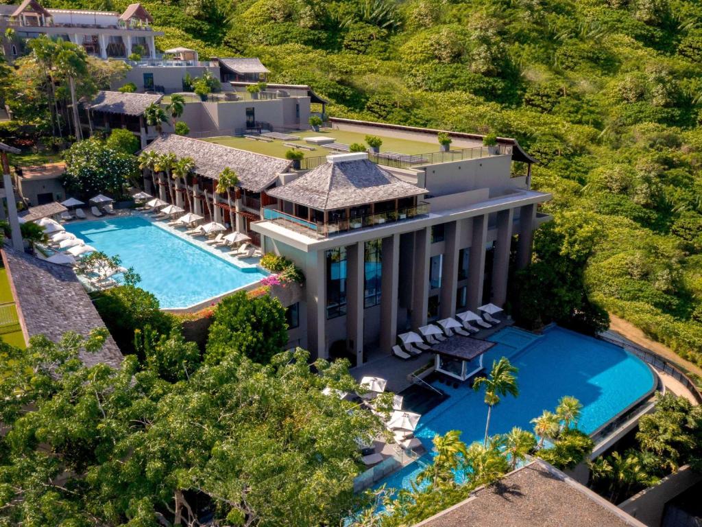 an aerial view of a mansion with a swimming pool at Avista Hideaway Phuket Patong - MGallery in Patong Beach