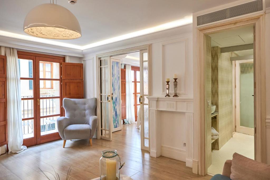 a living room with a chair and a window at Son Sant Jordi Boutique House in Pollença