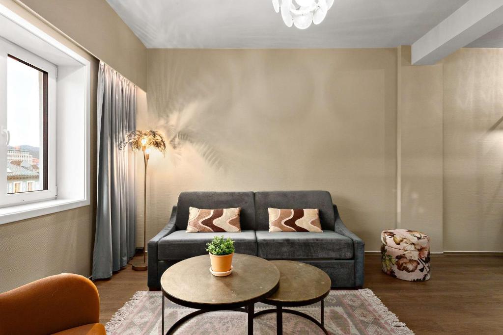 a living room with a couch and a table at Ole Bull, Best Western Signature Collection in Bergen