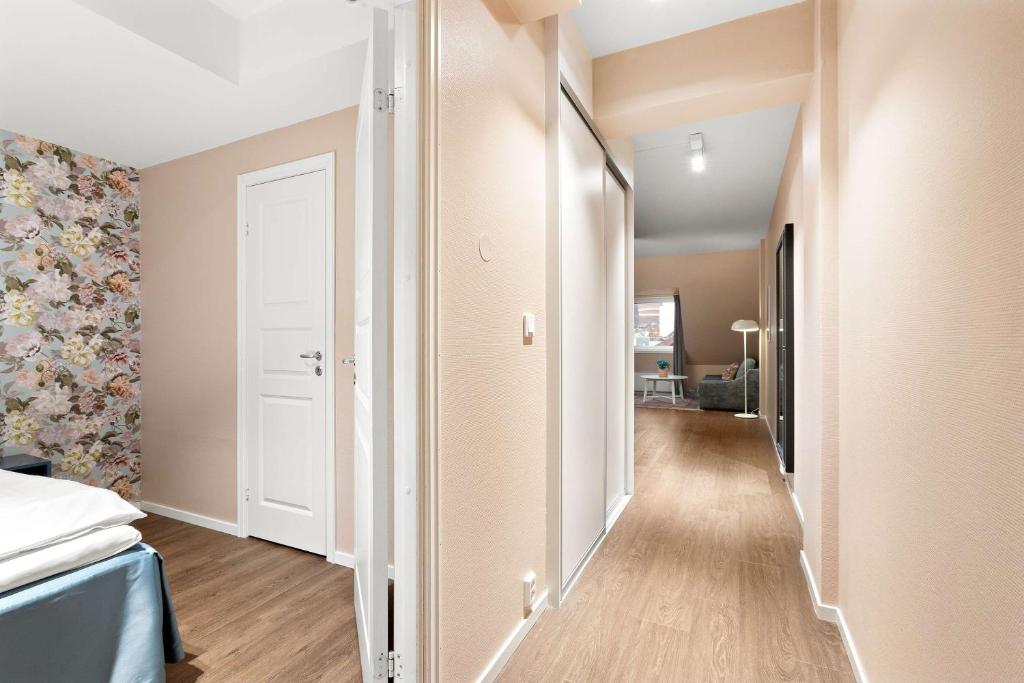 a corridor of a room with a bed and a door at Ole Bull, Best Western Signature Collection in Bergen