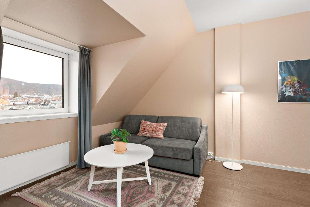 a living room with a couch and a table at Ole Bull, Best Western Signature Collection in Bergen