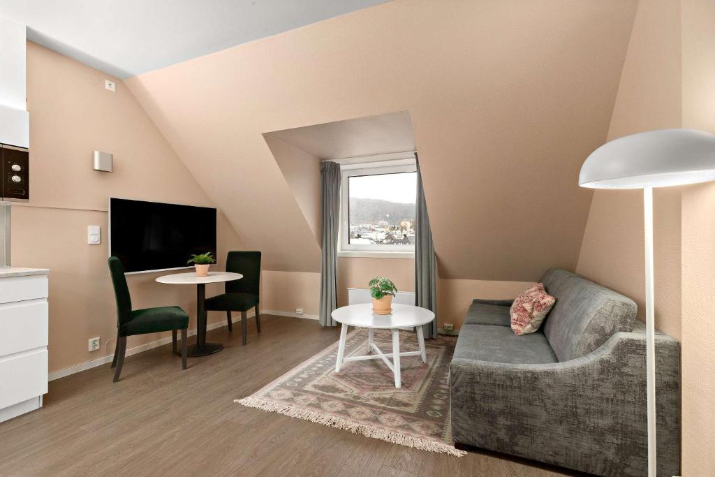 a living room with a couch and a table at Ole Bull, Best Western Signature Collection in Bergen