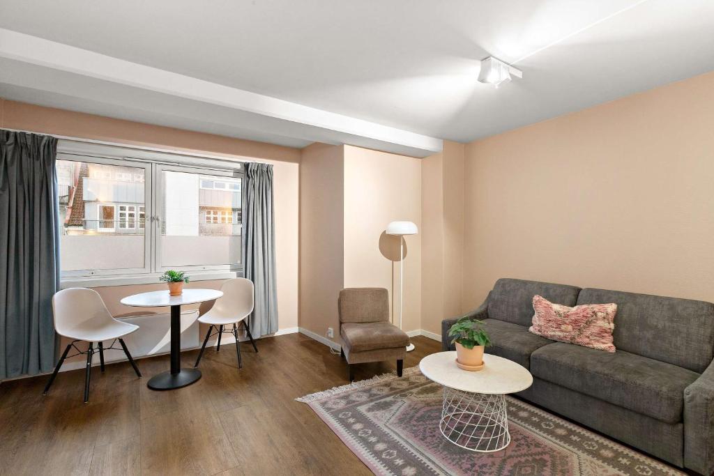 a living room with a couch and a table at Ole Bull, Best Western Signature Collection in Bergen
