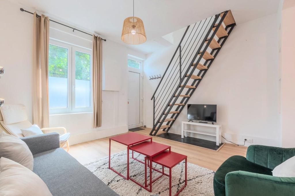 een woonkamer met een bank en een trap bij 2 BR house w/ terrace, near train stations & metro in Lille