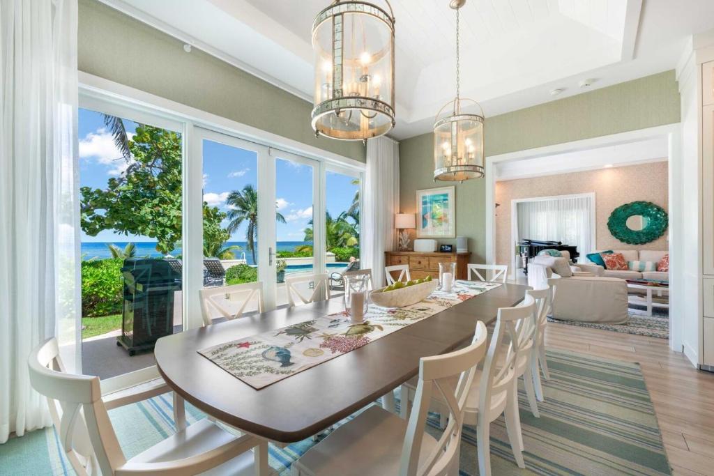 a dining room and living room with a table and chairs at Gypsy Villa home in Driftwood Village