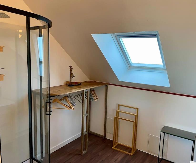 a skylight in a room with a table and a window at La Désirade by Póm in Lorient
