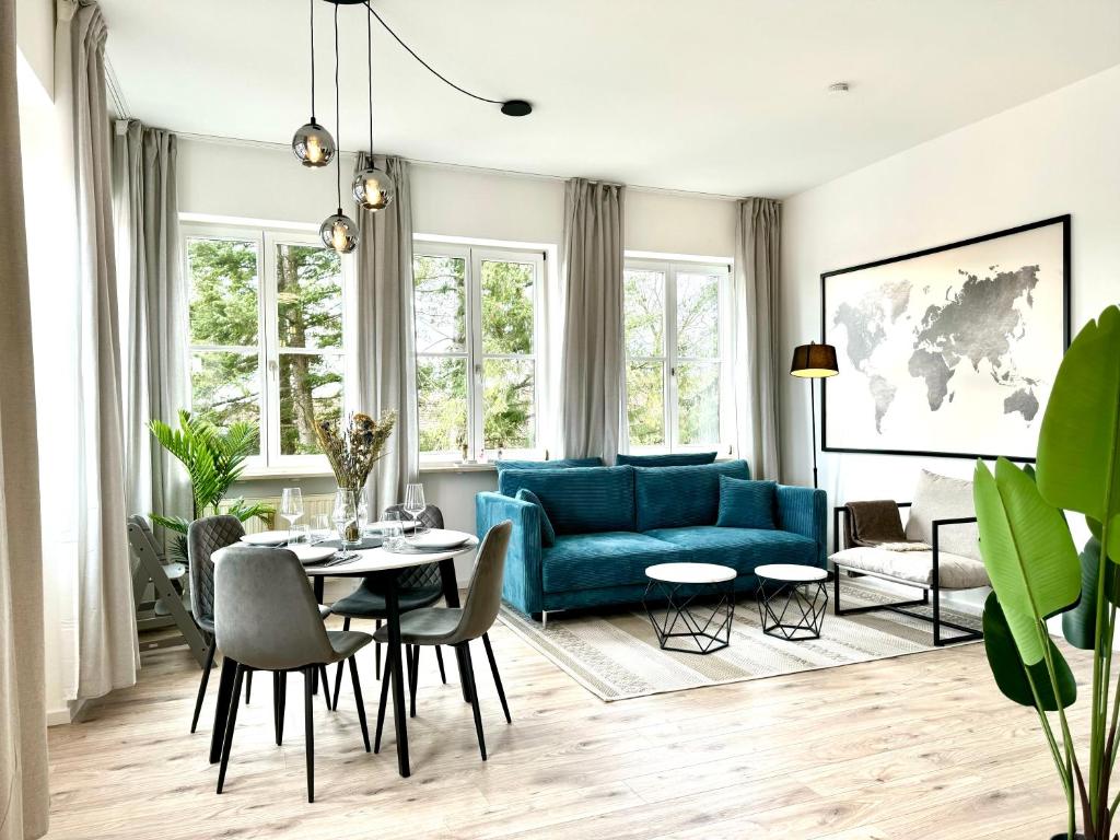 uma sala de estar com um sofá azul e uma mesa em E&K living - city central - design apartment - kitchen - free parking em Gersthofen