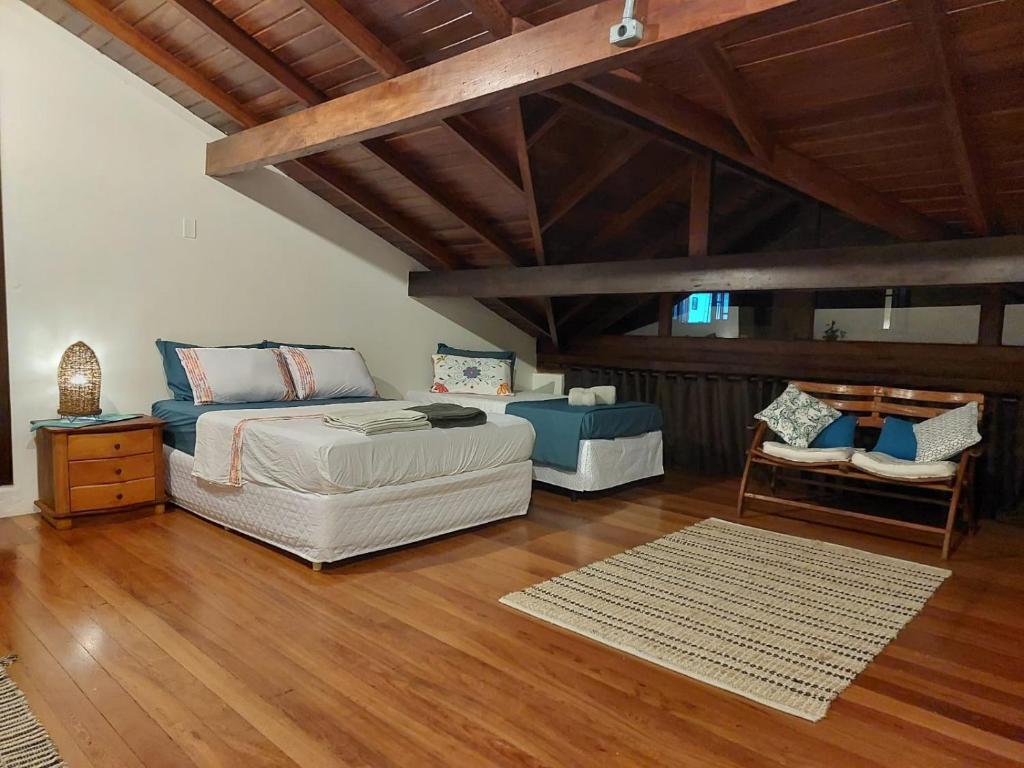 a bedroom with a bed and a wooden ceiling at Brisas do Sambaqui in Florianópolis